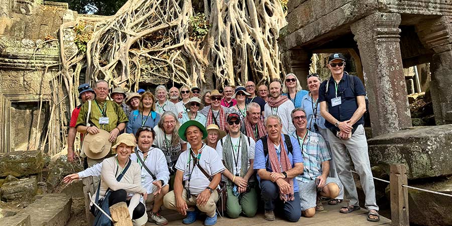 Tim photographed with a tour group, in front of Angkor Wat. 